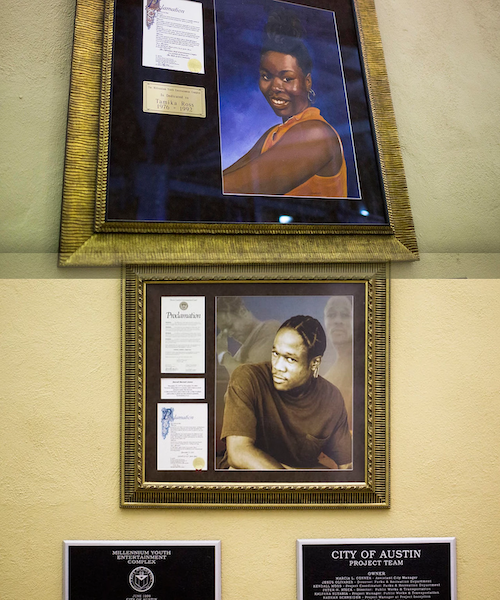 Two plaques with gold frames stacked on top of each other. The top one has a Proclamation (too blurry to read) and an inscription that reads "The Millennium Youth Entertainment Complex is dedicated to Tamika Ross 1976-1992" and has a picture of a smiling Tamika Ross, a black female wearing an orange shirt, and gold earrings, with her hair up. The bottom plaque has proclamations too blurry to read alongside a picture of a Juan Cotera, a black male wearing a dark t-shirt with a breast pocket.